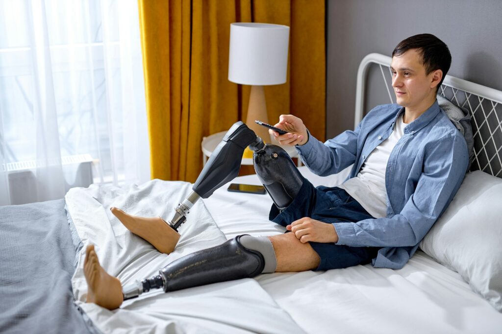 Home entertainments. pleasant handicapped guy with TV controller enjoying movie indoors